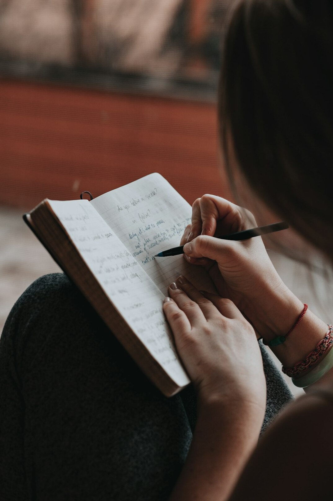 person writing notes on communication