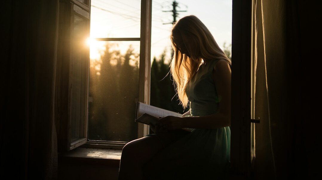 woman reading self help book