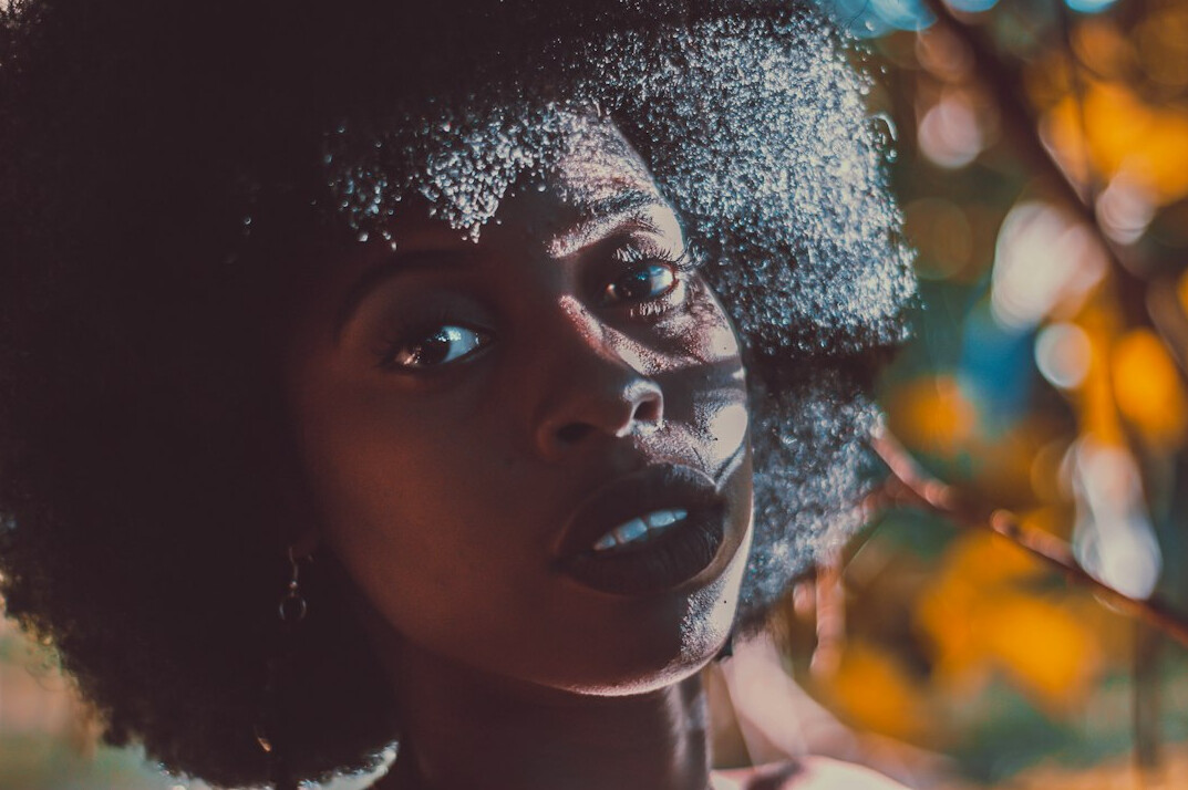 Studio portrait of a young afro-brazilian woman with braids