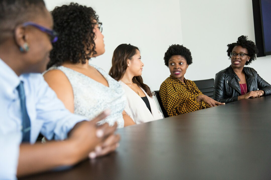 confident business woman talking to group